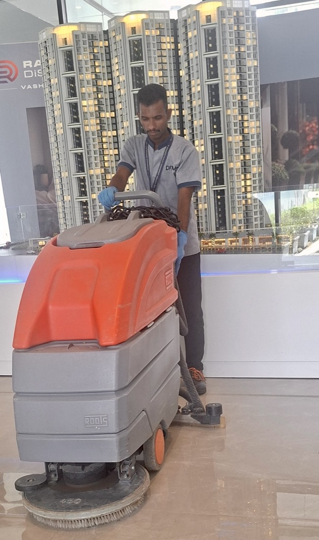 DFMS technician with industrial floor scrubber